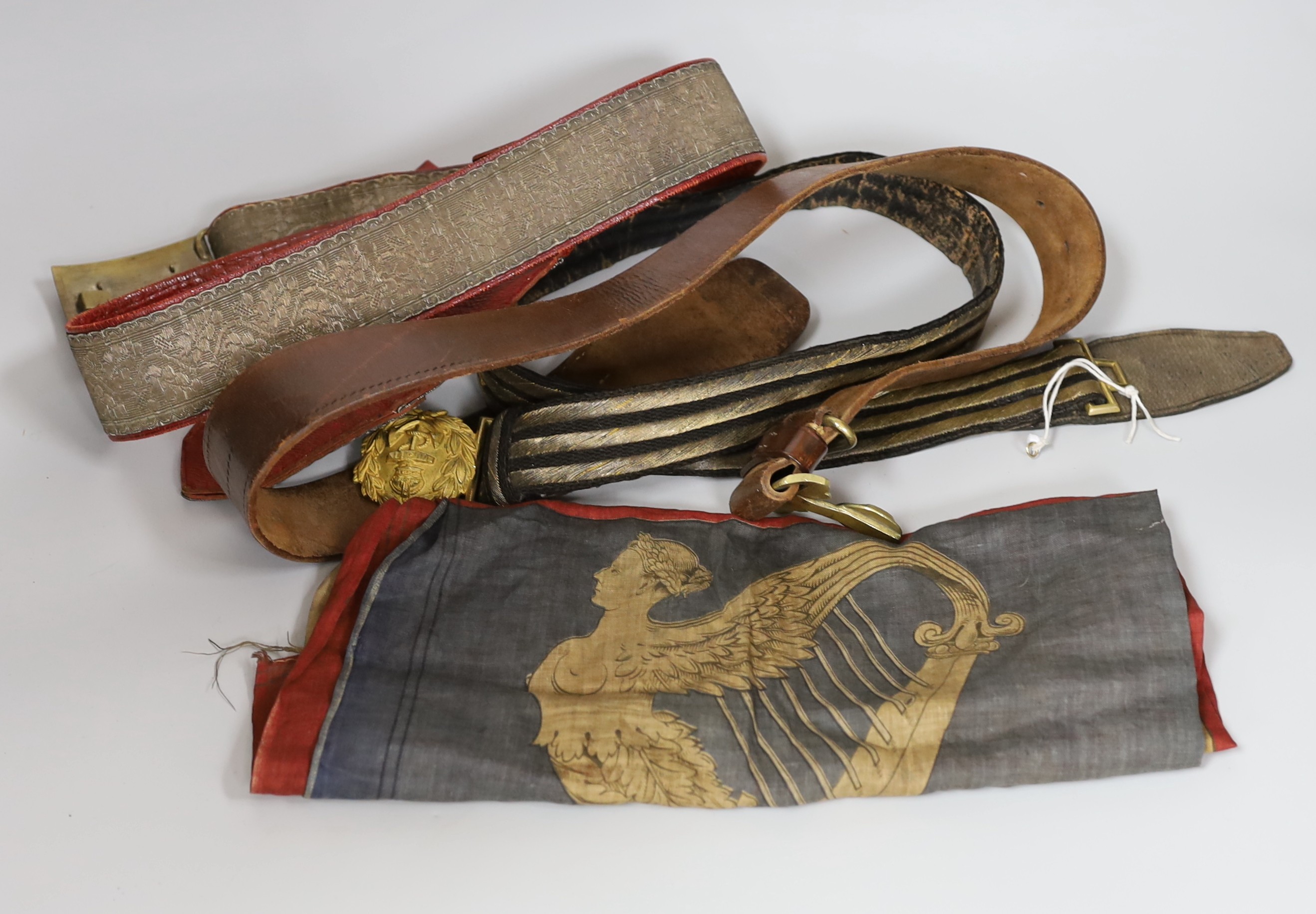 A Royal Naval gilt brass mounted officers belt, an Edwardian Dieu et mon droit belt, a Victorian printed flag and A Victorian Yorkshire Regiment officers brocade sword belt